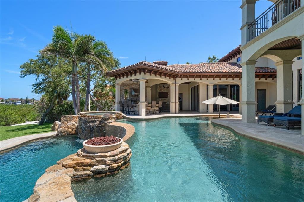 10930 Spring Street Largo, FL 33774 - Photo 50 of 100 a front view of a house with swimming pool garden and patio