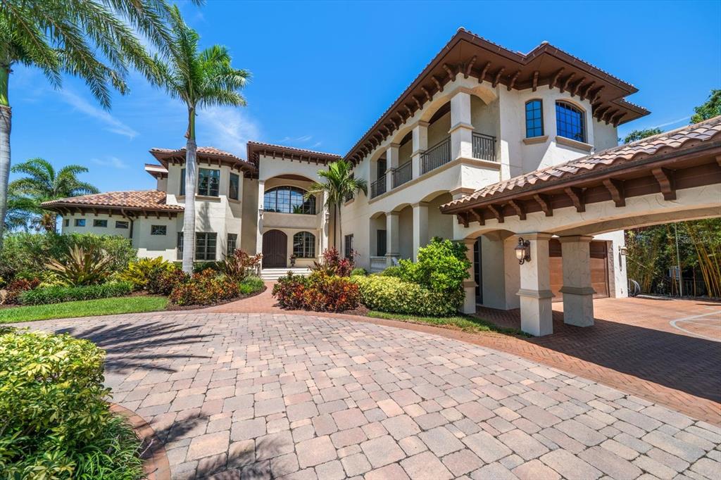 10930 Spring Street Largo, FL 33774 - Photo 7 of 100 a front view of a house with a yard and potted plants