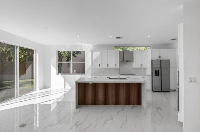a kitchen with granite countertop a sink and a refrigerator