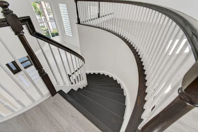 an empty room with wooden floor and window