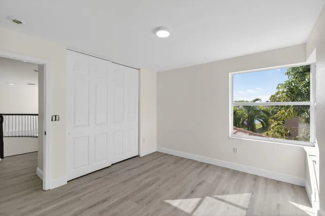 a view of a yard with plants and tree