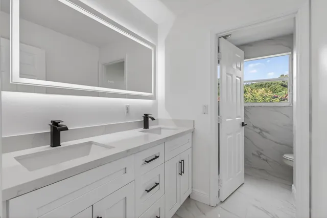 a yellow house with trees in front of it