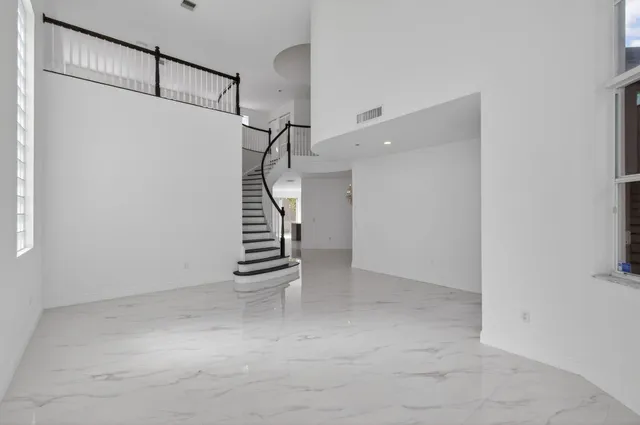 a bathroom with a toilet sink vanity and granite