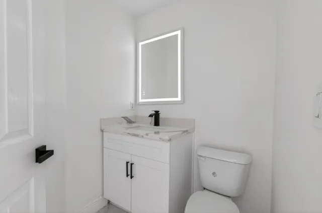 a kitchen with stainless steel appliances kitchen island granite countertop a refrigerator and a stove top oven