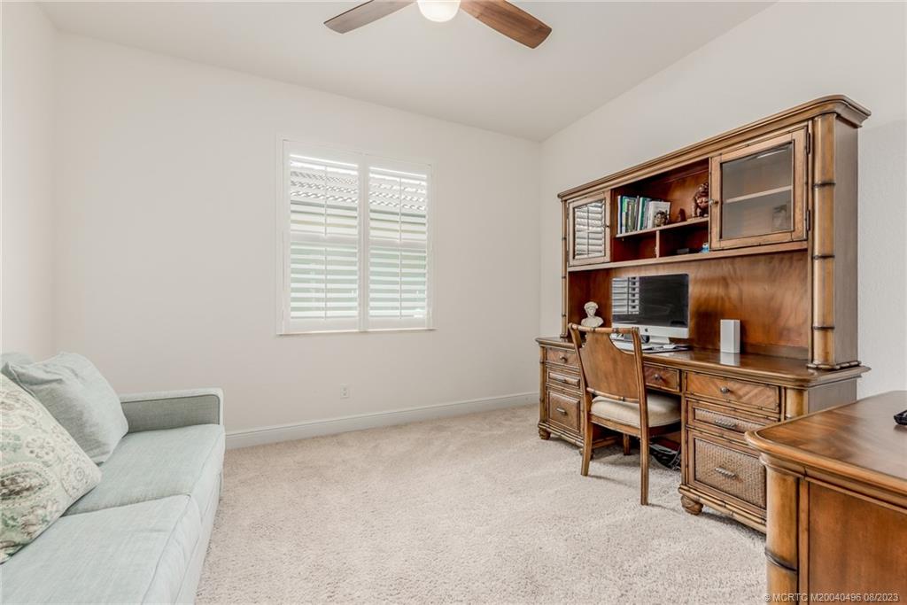 5891 Southeast Entry Court Stuart, FL 34997 - Photo 13 of 29 a living room with furniture a window and a flat screen tv