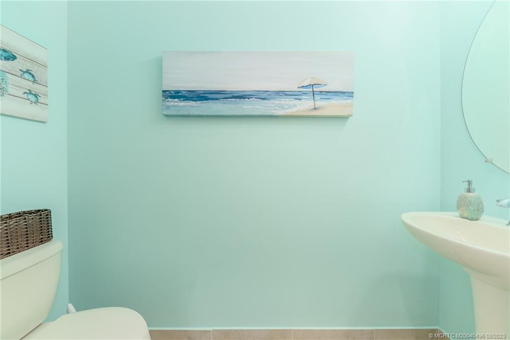 5891 Southeast Entry Court Stuart, FL 34997 - Photo 15 of 29 a bathroom with a sink and a toilet