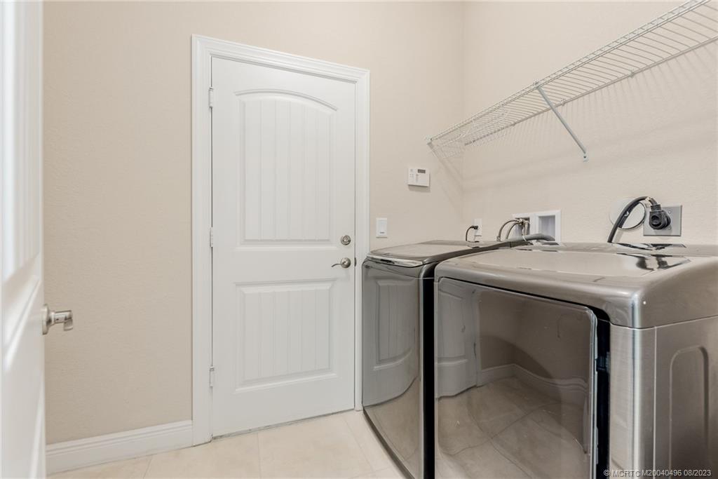 5891 Southeast Entry Court Stuart, FL 34997 - Photo 16 of 29 a utility room with dryer and washer