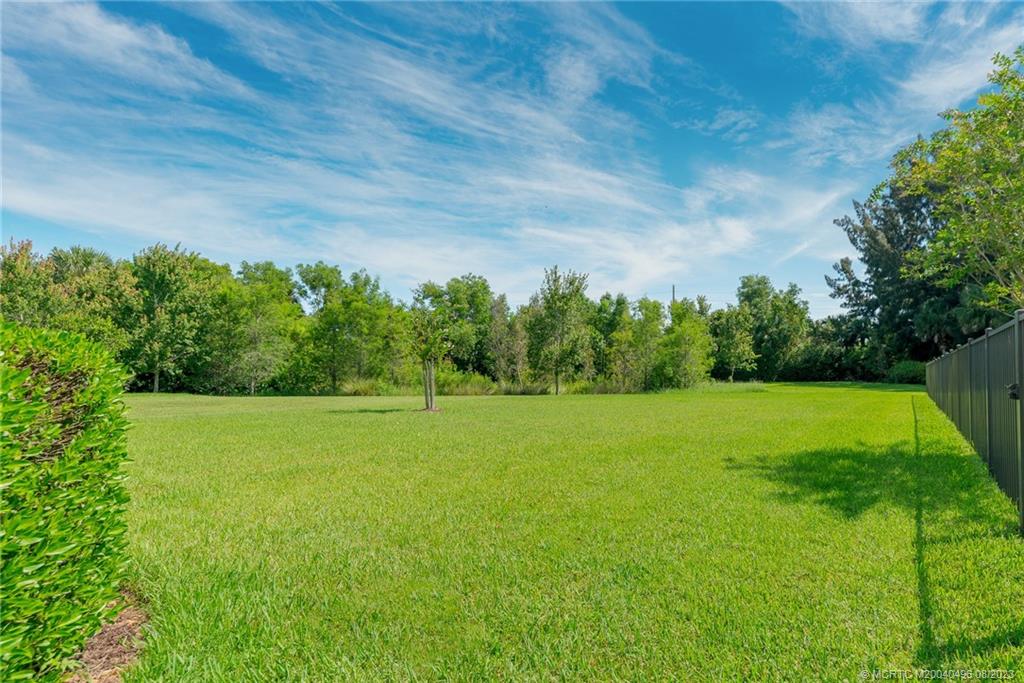 5891 Southeast Entry Court Stuart, FL 34997 - Photo 19 of 29 a view of field with trees in the background