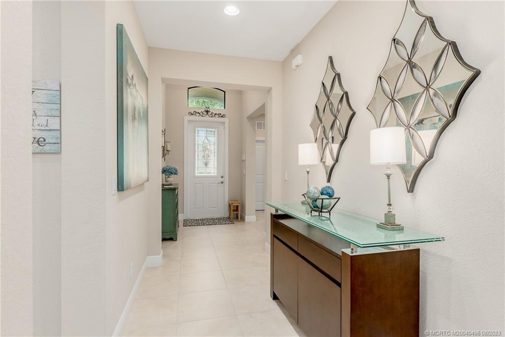 5891 Southeast Entry Court Stuart, FL 34997 - Photo 3 of 29 a bathroom with a sink and mirror