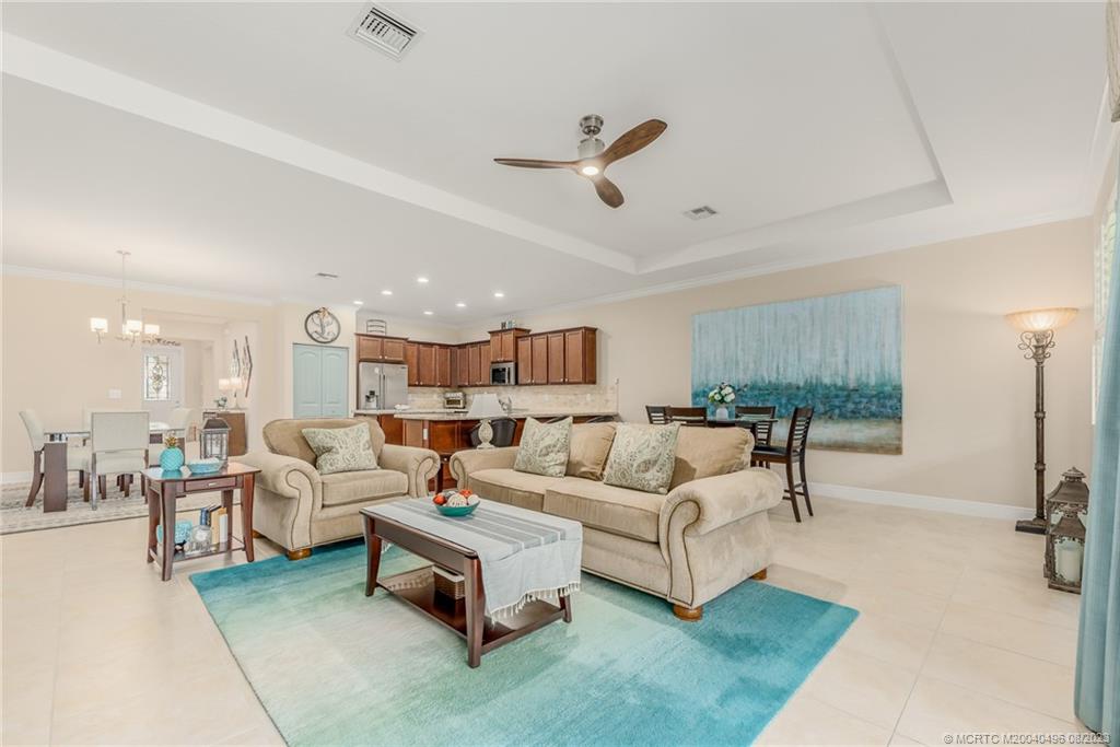5891 Southeast Entry Court Stuart, FL 34997 - Photo 5 of 29 a living room with furniture and a large window