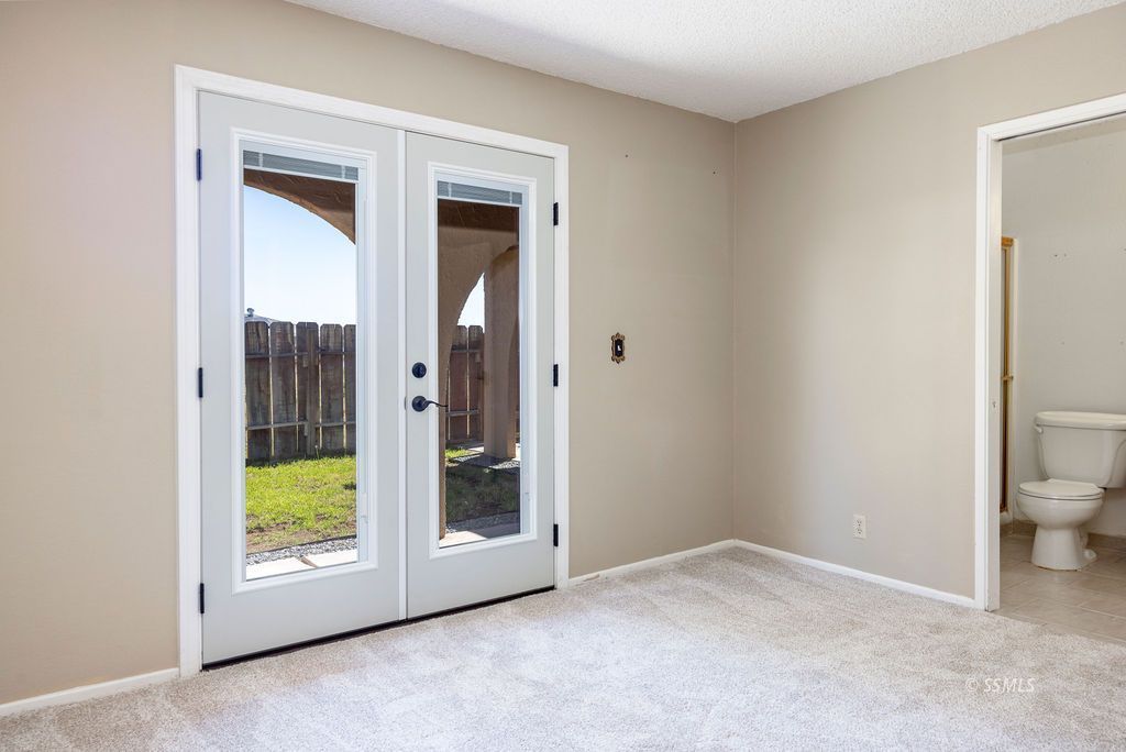 1144 West Benson Avenue Ridgecrest, CA 93555 - Photo 22 of 32 a view of an empty room with a bathroom and a window