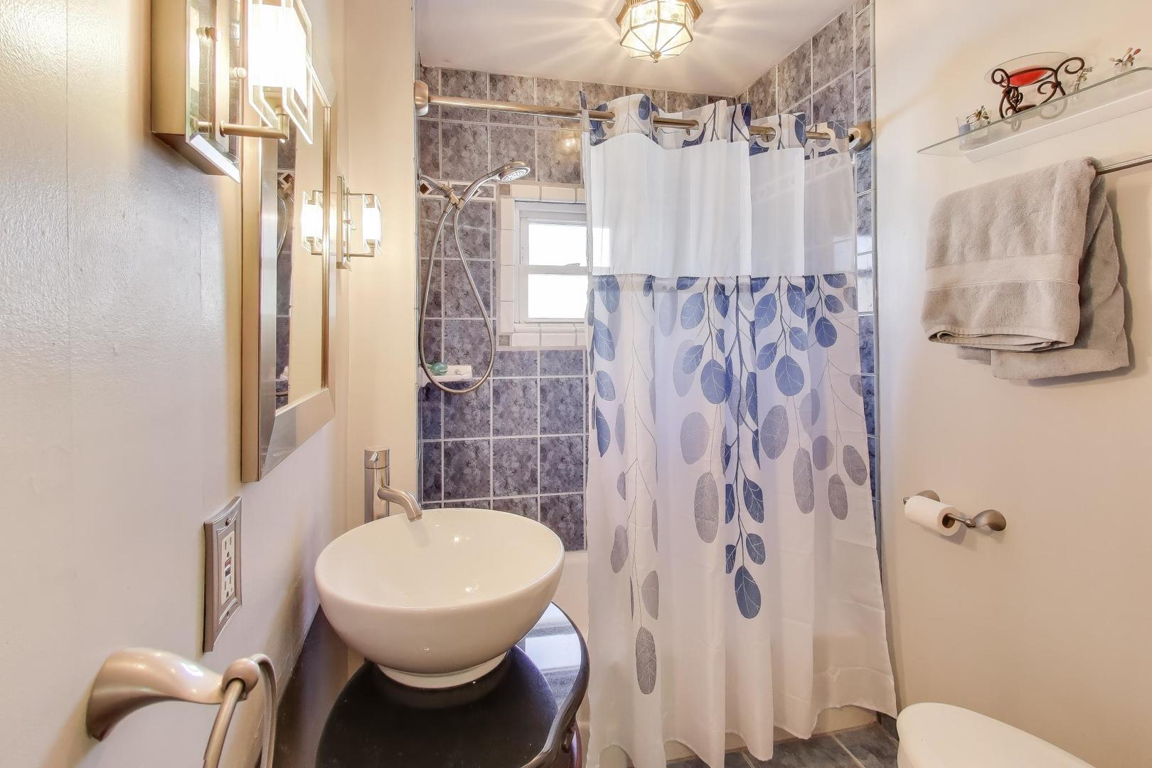 365 Walnut Street Elmhurst, IL 60126 - Photo 11 of 19 a bathroom with a sink toilet and shower