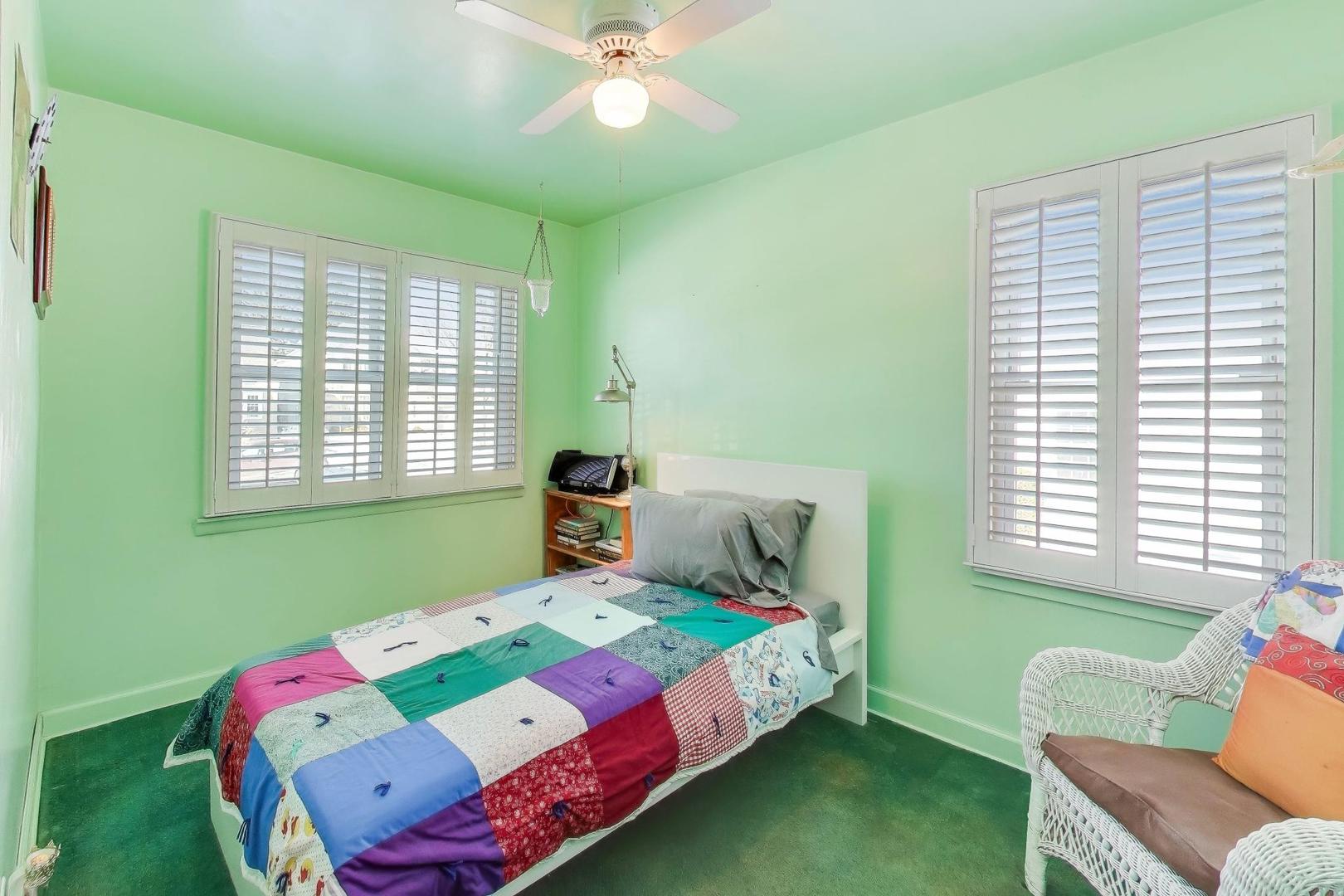 365 Walnut Street Elmhurst, IL 60126 - Photo 12 of 19 a bedroom with a bed and a chair