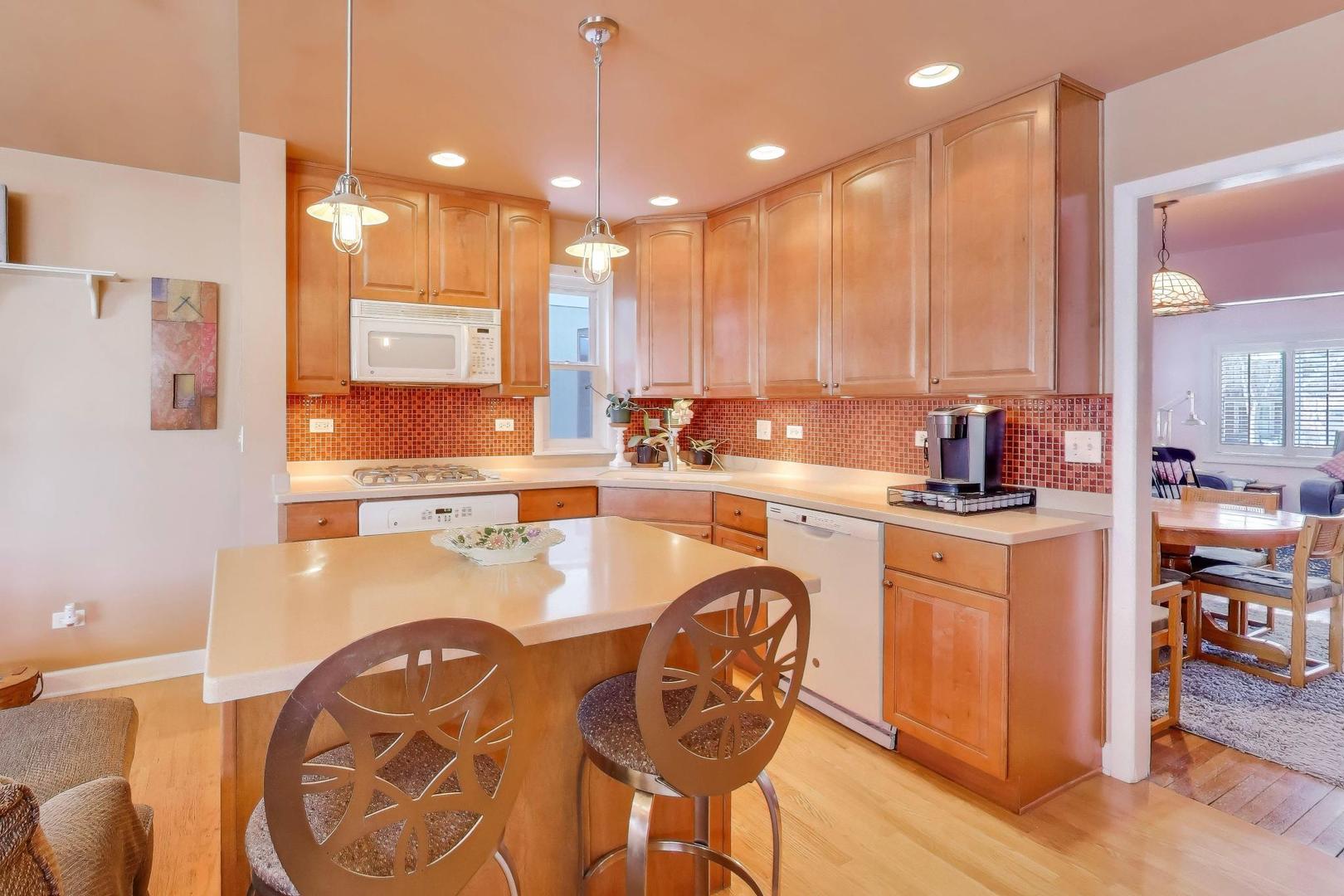 365 Walnut Street Elmhurst, IL 60126 - Photo 3 of 19 a kitchen with a sink a stove and chairs