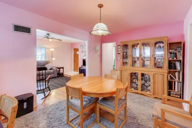 a view of a dining room with furniture and chandelier