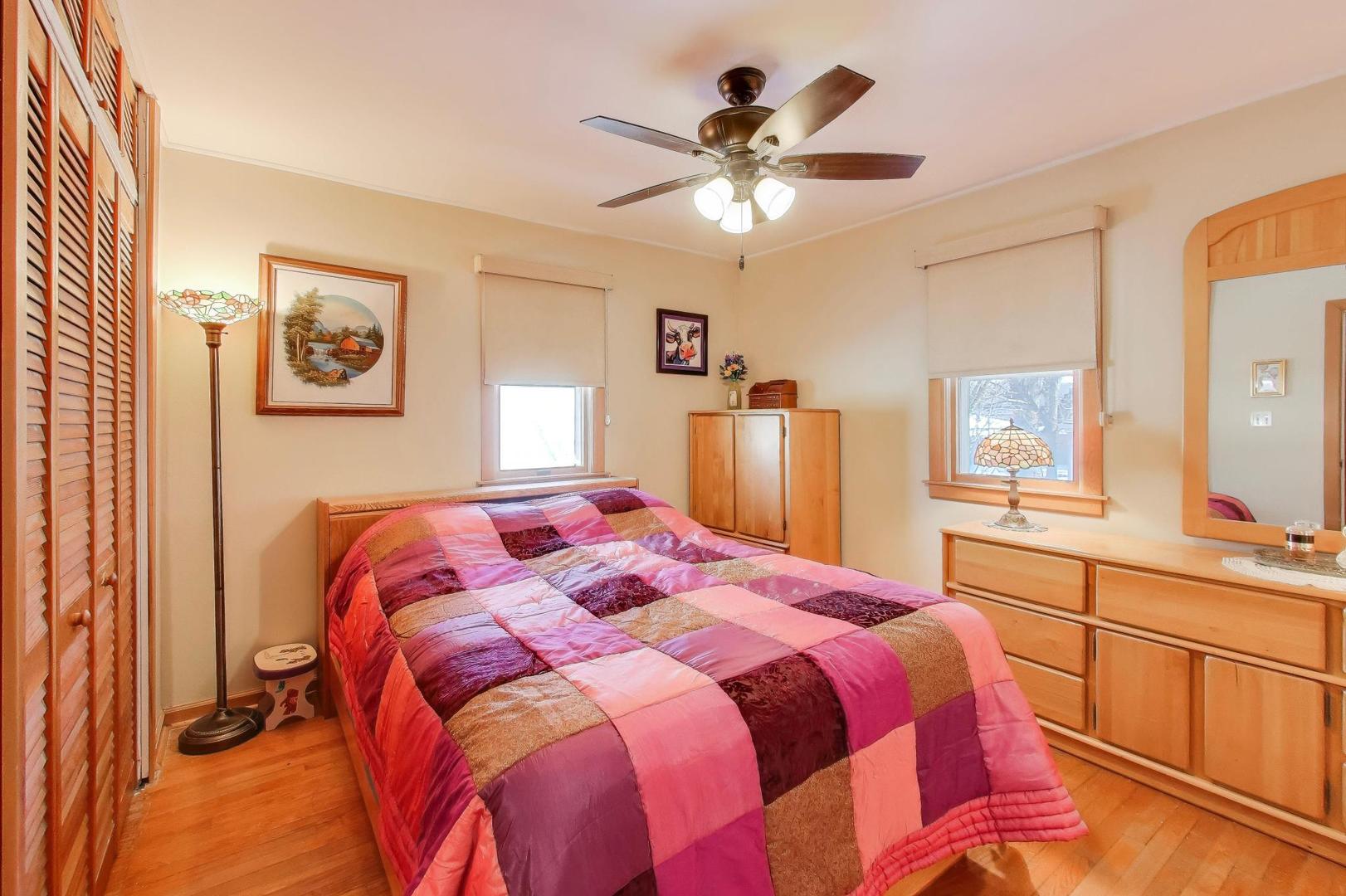 365 Walnut Street Elmhurst, IL 60126 - Photo 10 of 19 a bedroom with a bed and a chandelier