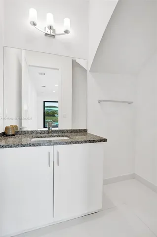 an empty room with wooden floor and a ceiling fan