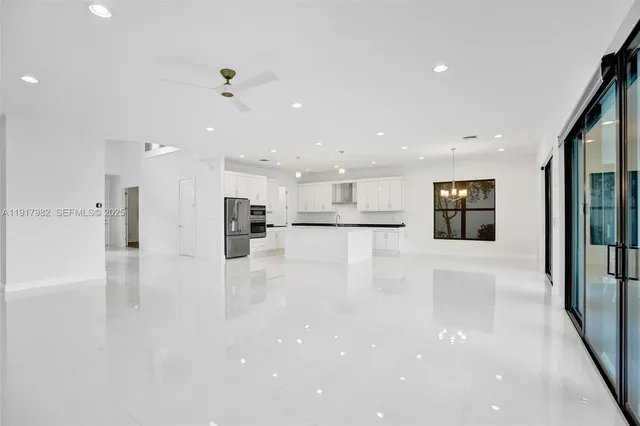 a bathroom with a granite countertop sink a toilet and a mirror
