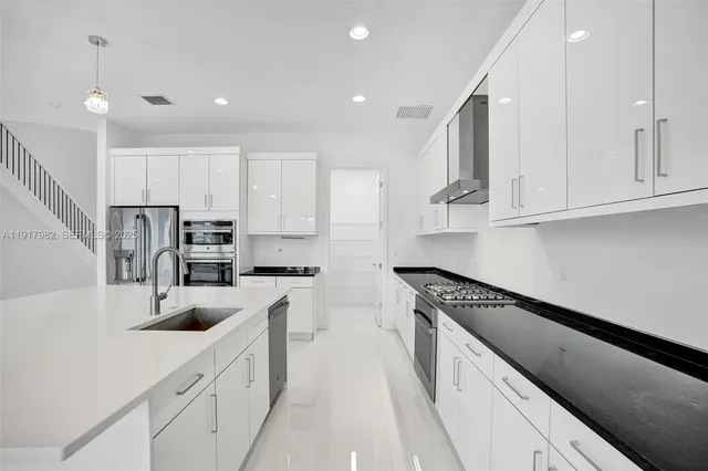 an empty room with wooden floor and ceiling fan