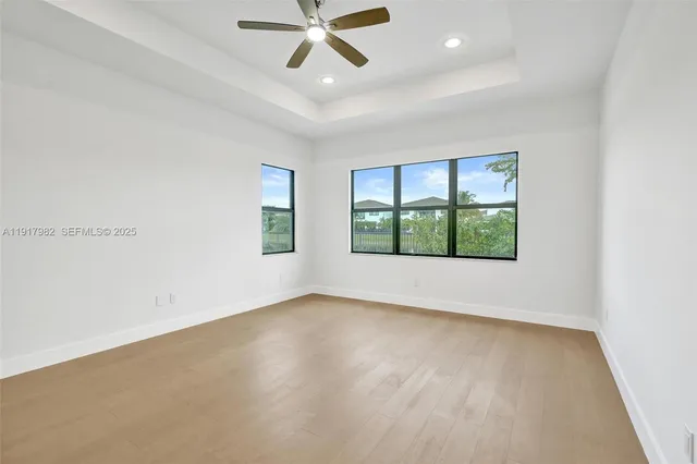 a sign of golf club on a wall under a tree