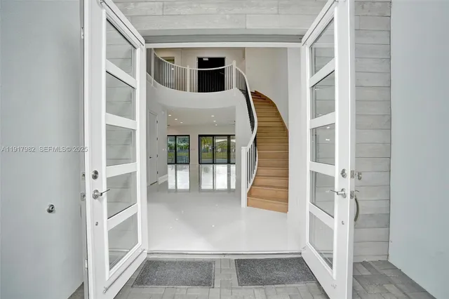 a kitchen with kitchen island granite countertop a sink a counter space stainless steel appliances and cabinets
