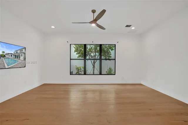 a bathroom with a granite countertop sink toilet and a mirror
