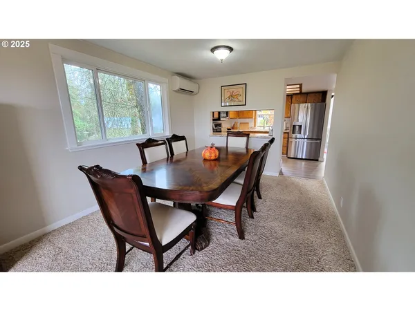 a dining room with furniture and window
