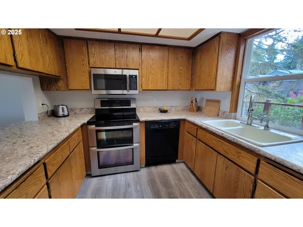 a kitchen with a sink a stove and cabinets