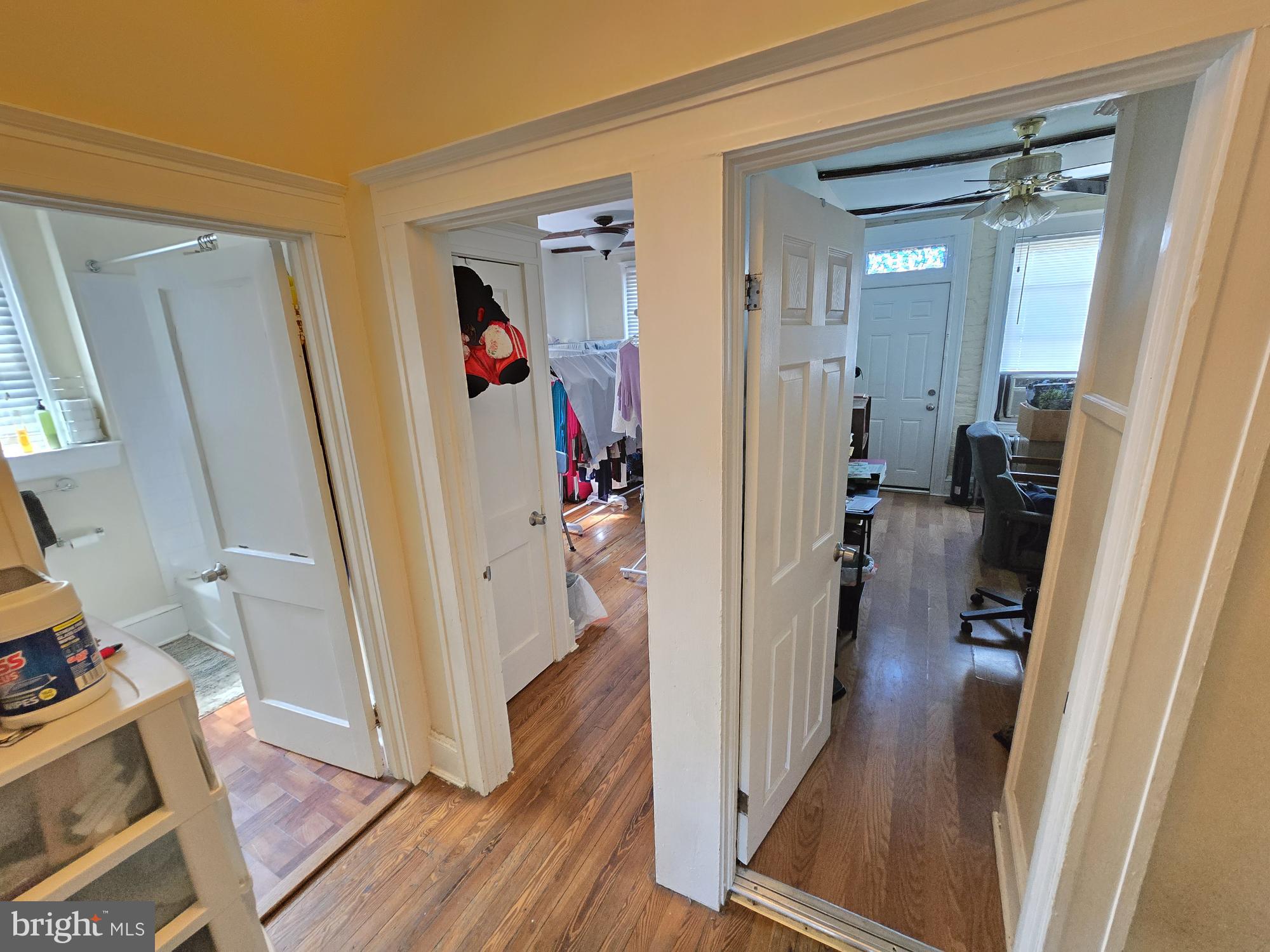 816 Primson Avenue Baltimore, MD 21229 - Photo 14 of 23 a view of a hallway with wooden floor and stairs