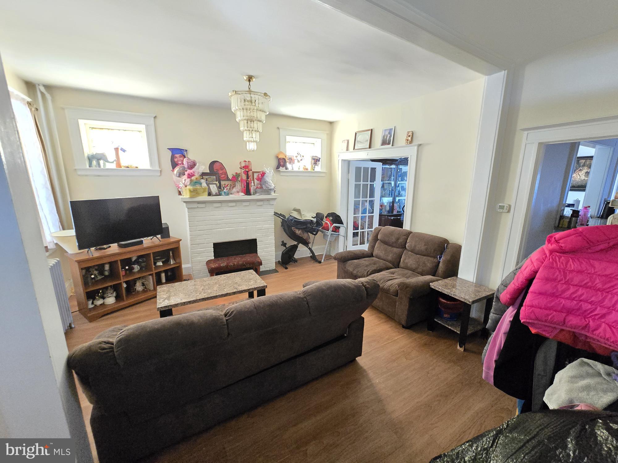 816 Primson Avenue Baltimore, MD 21229 - Photo 5 of 23 a living room with furniture a flat screen tv and a fireplace