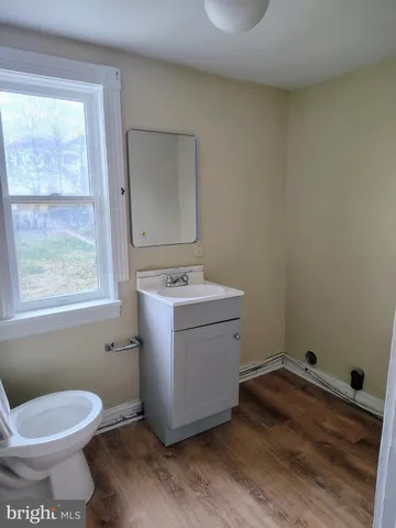a view of bathroom with a toilet sink and mirror