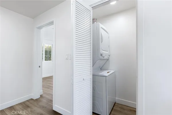 an entryway with a door and wooden floor