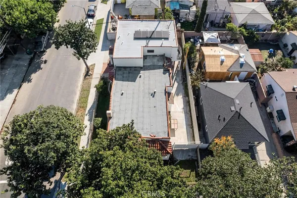 an aerial view of a residential apartment building with a yard