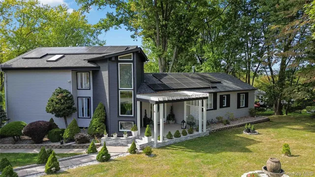 a backyard of a house with yard table and chairs