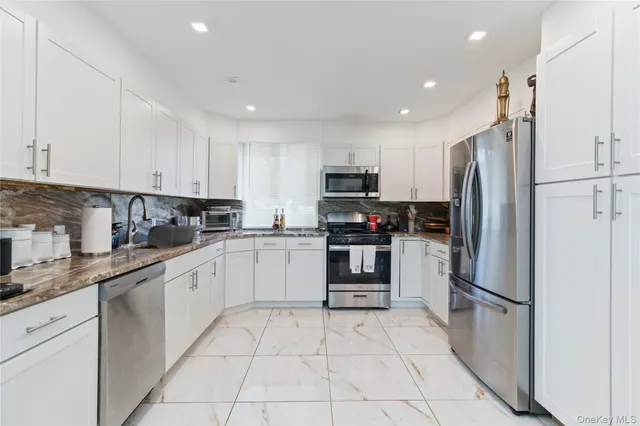 a kitchen with a refrigerator a sink and cabinets