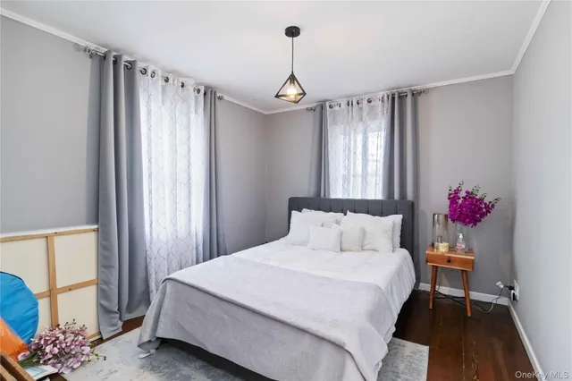 a bedroom with a bed dresser and a window