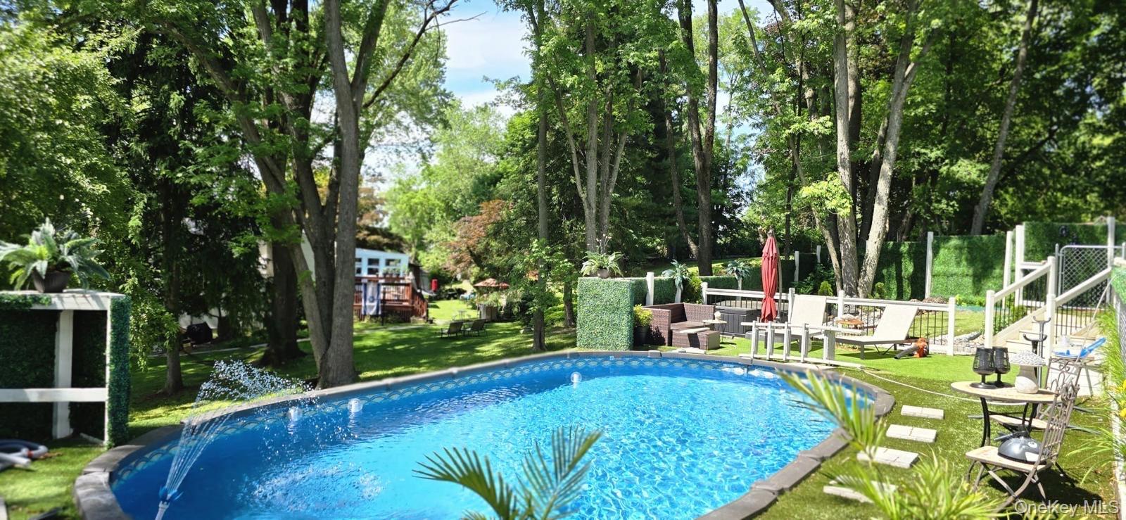 46 Woodland Road Monroe, NY 10950 - Photo 19 of 39 a view of a swimming pool with a patio