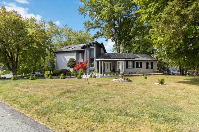 a front view of house with yard swimming pool and seating space