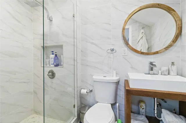 a bathroom with a sink a toilet and a mirror