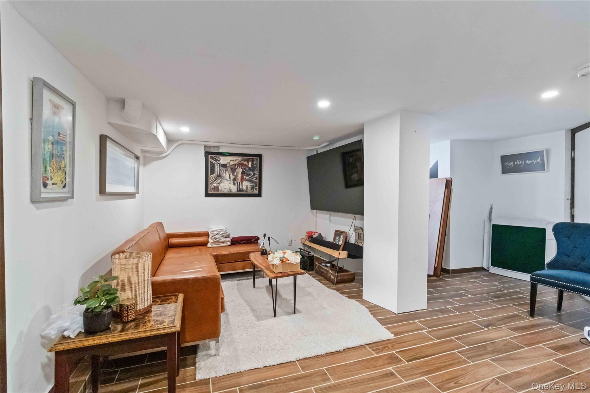 46 Woodland Road Monroe, NY 10950 - Photo 23 of 39 a living room with furniture and a flat screen tv