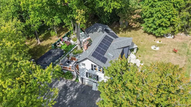 view of a house with a yard and a garden