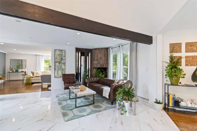 a living room with furniture and large windows