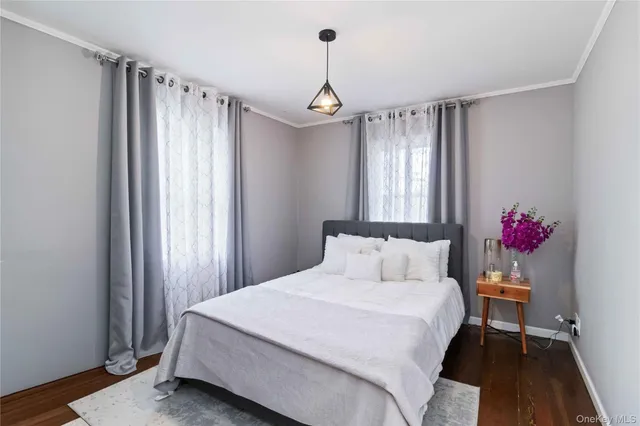 a bedroom with a bed dresser and a window