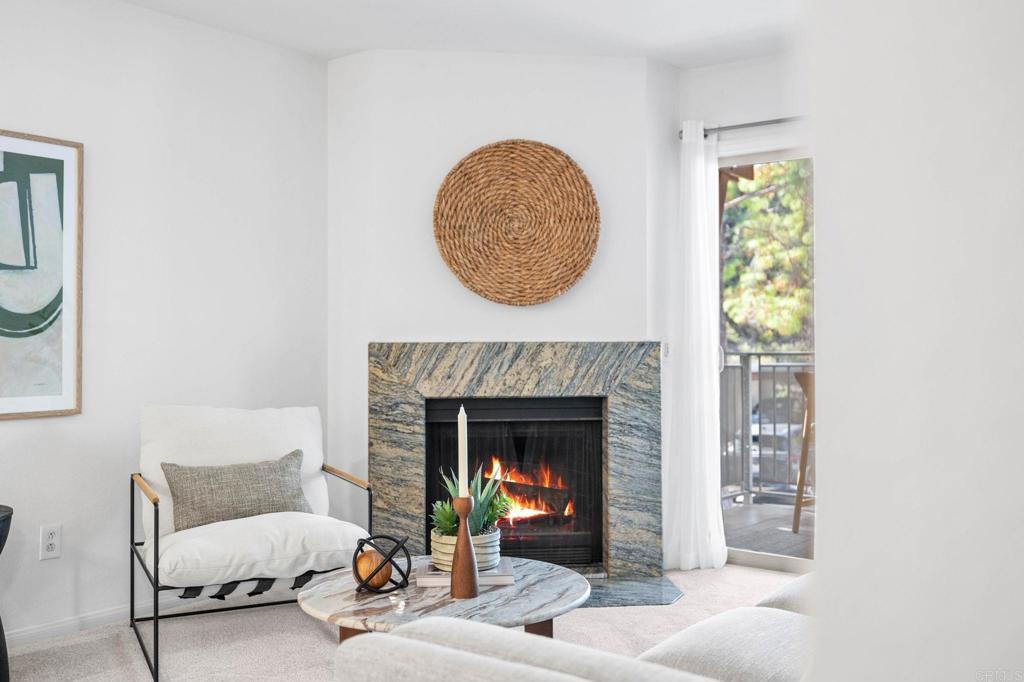 1750 South El Camino Real, Unit 211 Encinitas, CA 92024 - Photo 12 of 44 a living room with furniture and a fireplace