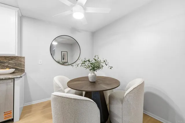a dining room with furniture and a mirror