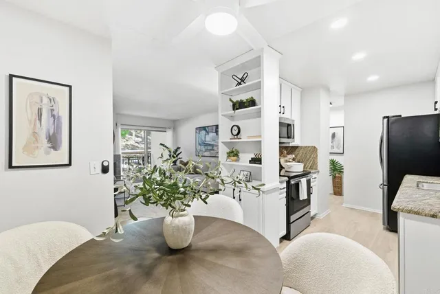 a kitchen with stainless steel appliances kitchen island granite countertop a refrigerator and stove