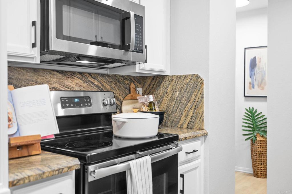 1750 South El Camino Real, Unit 211 Encinitas, CA 92024 - Photo 21 of 44 a kitchen with a stove and a microwave