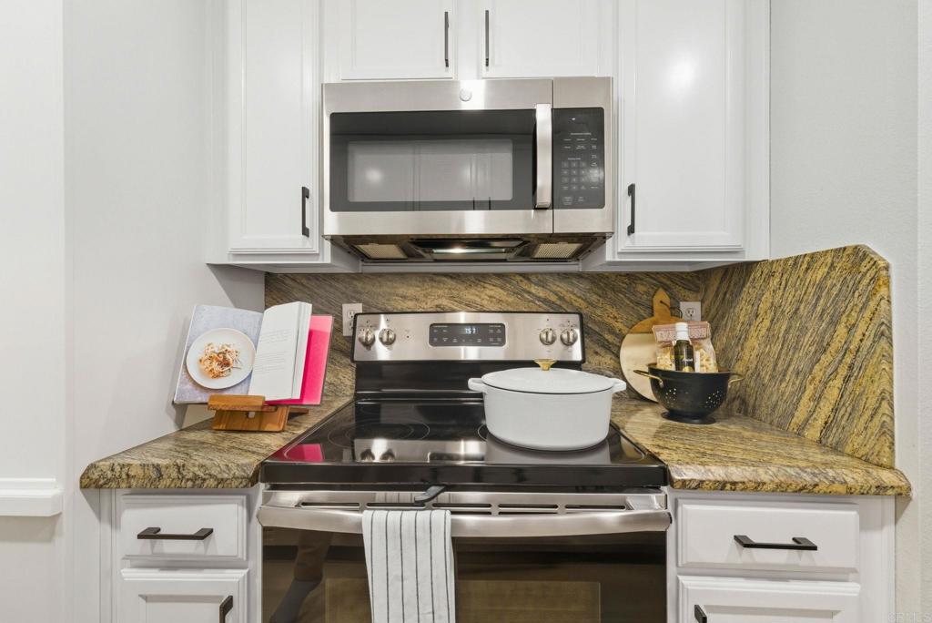 1750 South El Camino Real, Unit 211 Encinitas, CA 92024 - Photo 22 of 44 a stove top oven sitting inside of a kitchen