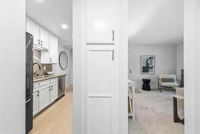 a kitchen with stainless steel appliances a refrigerator and cabinets
