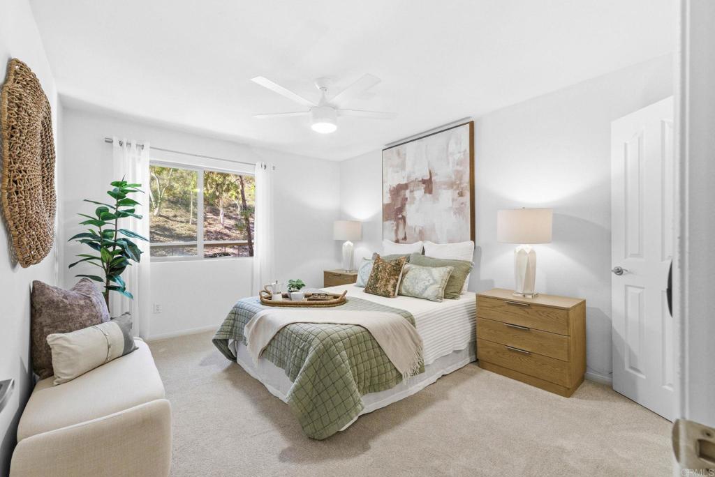 1750 South El Camino Real, Unit 211 Encinitas, CA 92024 - Photo 30 of 44 a bedroom with a bed and a couch